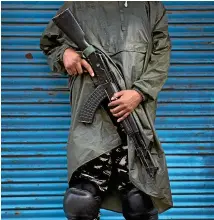  ?? AP ?? Soldiers dress for a combat zone in down-town Srinagar.
