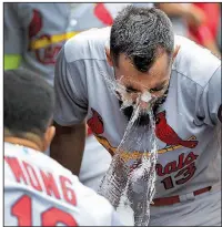  ?? AP/CHARLES REX ARBOGAST ?? Matt Carpenter of the St. Louis Cardinals has ice water tossed in his face by teammate Kolten Wong after hitting his third home run Friday during the Cardinals’ 18-5 victory over the Chicago Cubs.