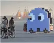  ?? TREVOR HUGHES, USA TODAY ?? At Burning Man, a ghost from PacMan trundles across the desert.