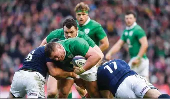  ??  ?? Tadhg Furlong is stopped in his tracks by Scotland duo Josh Strauss and Gordon Reid.