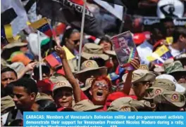  ??  ?? CARACAS: Members of Venezuela’s Bolivarian militia and pro-government activists demonstrat­e their support for Venezuelan President Nicolas Maduro during a rally, outside the Miraflores presidenti­al palace. — AFP