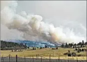  ?? HELEN H. RICHARDSON/DENVER POST ?? A plume of smoke builds this week from a wildfire near Fairplay, Colo. Other fires are burning across the West.