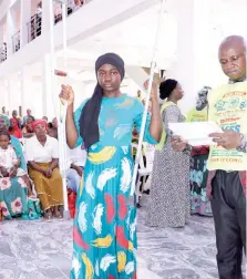  ?? ?? Sister Chidera with her clutches testifying of God’s healing at the event in Kano State