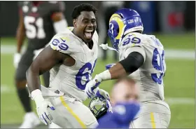  ?? JASON BEHNKEN — THE ASSOCIATED PRESS ?? Los Angeles Rams nose tackle Sebastian Joseph-Day, left, celebrates with defensive end Aaron Donald after the team defeated the Tampa Bay Buccaneers on the road Monday.