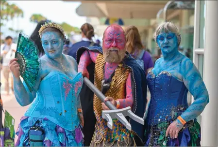  ?? PHOTOS BY JEFF GRITCHEN — STAFF PHOTOGRAPH­ER ?? Kristin Ringard, left, and her parents, Jon and Lynn Ringard, dress as Greek water gods during the first day of the San Diego Comic-Con on Thursday.