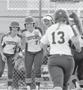  ?? Jerry Baker ?? Kendall McGary, left, and Zoe Pruden are eager to greet Tompkins teammate Mackenzie Brown, right after Brown hit a grand slam in the first inning Friday.