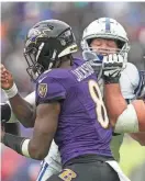  ?? JENNA WATSON/INDYSTAR ?? Colts defensive tackle Taven Bryan, back, forces a fumble by bumping the ball out of the hand of Baltimore quarterbac­k Lamar Jackson on Sept. 24, 2023.