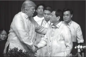  ?? AP/ANDREW HARNIK ?? President Donald Trump greets Philippine­s President Rodrigo Duterte at an Associatio­n of Southeast Asian Nations summit dinner Sunday in Manila.