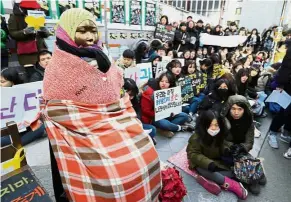  ?? — AP ?? Landmark statue: Students gathering near the ‘comfort woman’ statue during a rally in front of the Japanese Embassy in Seoul.