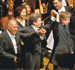  ?? Francine Orr Los Angeles Times ?? THREE L.A. Phil music directors — Zubin Mehta, left, Gustavo Dudamel and EsaPekka Salonen — celebrate during a gala concert in 2019.