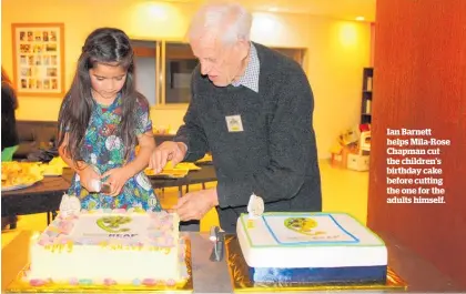  ?? ?? Ian Barnett helps Mila-Rose Chapman cut the children’s birthday cake before cutting the one for the adults himself.