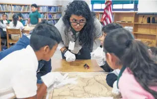  ?? Jerry Lara / Staff photograph­er ?? Fourth grade teacher Jennifer Cruz engages her students at Storm Relay Lab Elementary School, where Land Commission­er George P. Bush gave a history lesson to two classes on Monday.