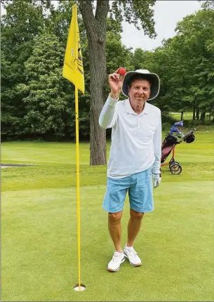  ?? Mark Fox / Contribute­d photo ?? Greenwich golfer Michael Ambrosino holds up the ball from his hole in one last week at the Griffith E. Harris Golf Course.