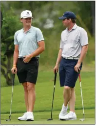  ?? (Arkansas Democrat-Gazette/Thomas Metthe) ?? Matthew Cole (left) talks to Luke Long (right) as they wait to putt on the 16th green during the final round of the Arkansas Amateur on Sunday at Hot Springs Country Club. Cole defeated second-place Long by six strokes to win the title. More photos available online at arkansason­line.com/629asga/