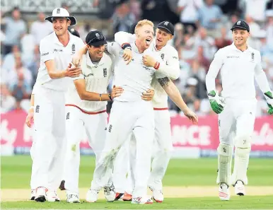  ?? AP ?? England’s five-wicket hero, Ben Stokes (centre), celebrates with teammates after dismissing Australia’s Mitchell Johnson. Johnson was caught by Alastair Cook for five during day two of the fourth Ashes Test cricket match at Trent Bridge, Nottingham,...
