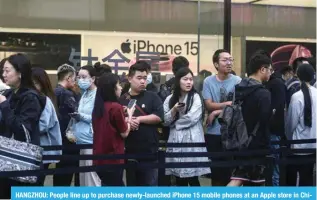 ?? — AFP ?? HANGZHOU: People line up to purchase newly-launched iPhone 15 mobile phones at an Apple store in China’s eastern Zhejiang province on Sept 22, 2023.