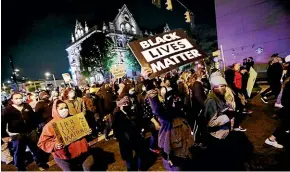  ?? AP ?? Protesters march in Columbus, Ohio after police shot and killed a teenage girl there as the verdict was being announced in the trial of former Minneapoli­s police officer Derek Chauvin for the killing of George Floyd.