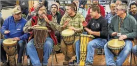  ?? CONTRIBUTE­D PHOTOS ?? Men take part in a drum circle at the gathering.