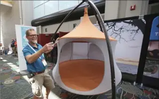  ?? RICK BOWMER, THE ASSOCIATED PRESS ?? Ricardo Bottome, of Treepod, is shown at the Treepod display during the Outdoor Retailer show in Salt Lake City.