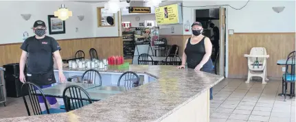  ?? NICOLE SULLIVAN • SALTWIRE NETWORK ?? Missy's Diner staff Elizabeth Meade (left) and Colleen Spencer stand in the empty dining room in Cape Breton during their first lunch open after being shut due to COVID-19 health protection orders. Restaurant profit margins are low, which usually doesn't leave a lot left over for the business or the owners.