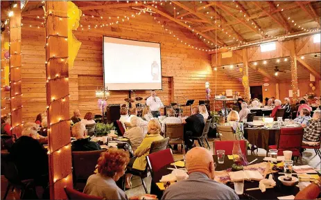  ?? Emily Jessen/Special to the Herald-Leader ?? Kind at Heart Ministry honored about 50 seniors and their family members at the organizati­on’s fifth annual banquet, held Saturday at the Cypress Barn. The event raised more than $20,000 for the nonprofit, thanks to donations from table sponsors.