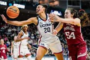  ?? Frank Franklin II / Associated Press ?? UConn forward Olivia Nelson-Ododa scored 10 points and grabbed 14 rebounds in a rout over Mackenzie Holmes, right, and Indiana.