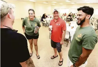  ?? Melissa Phillip photos / Houston Chronicle ?? From left, Noah Jones; Meghan Miller, the sister of fallen Marine Lance Cpl. Ryan A. Miller; Jordan Stepp; and Antonio Santiago, who served with Miller, share a story during the reunion Saturday.