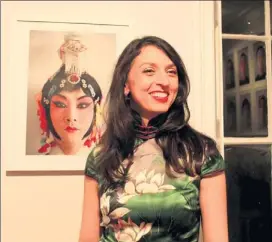  ?? CECILY LIU/ CHINA DAILY ?? Shavrova with one of her photos at the exhibition held in London.