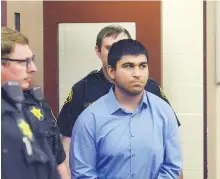  ??  ?? Arcan Cetin is escorted into Skagit County District Court by Skagit County sheriff's deputies on Monday.