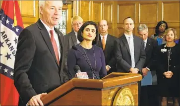  ?? Kelly P. Kissel Associated Press ?? ARKANSAS GOV. Asa Hutchinson, shown with Medicaid chief Seema Verma, has followed Trump’s lead in seeking Medicaid work requiremen­ts, which the administra­tion backed in a Supreme Court brief this week.