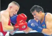  ?? GETTY ?? Manoj Kumar (right) fights with Terry Nickolas of Australia.