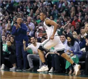  ?? CHARLES KRUPA — THE ASSOCIATED PRESS ?? Fans cheer as Boston’s Avery Bradley heads down court after hitting a 3-pointer during the second quarter of Game 5 in Boston on Wednesday. Bradley scored 29 as the Celtics defeated the Washington Wizards, 123-101.