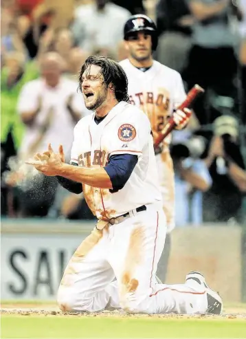  ?? Karen Warren / Houston Chronicle ?? It was a dirty job for Astros center fielder Jake Marisnick to turn an attempted steal of second base into a run in the fifth inning as he took advantage of a throwing error by Red Sox catcher Ryan Hanigan to take a tour of the bases that ended with a...