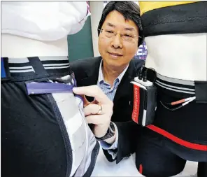  ?? Ed kaiser, the journal ?? Dr. Ming Chan of Glenrose Rehabilita­tion Hospital shows off electrodes imbedded in the Smart-e-pants, which are now being tested in Alberta hospitals to prevent pressure ulcers among people with spinal cord injuries.