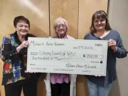  ?? Virginia Pitts / Malvern Daily Record ?? Kiwanis Club members Dottie Tarlton (left) and President Gretchen Ritchey (right) present Vicki Mcnees from the Literacy Council of HSC (center) with a $200 donation at their March meeting.