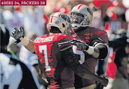  ?? Carlos Avila Gonzalez / The Chronicle ?? 49ers lineman Alex Boone celebrates with Colin Kaepernick in the first half after one of Kaepernick’s three touchdown passes.