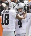  ?? Aaron Josefczyk / Associated Press ?? Andre Holmes and Derek Carr celebrate their 3-yard TD pass play in the first half.