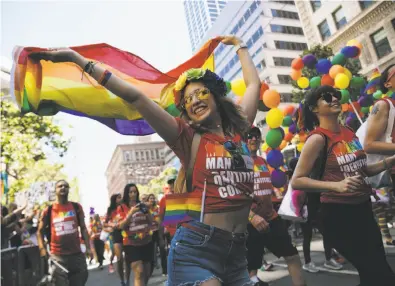  ?? Mason Trinca / Special to The Chronicle ?? A member of the Gilead contingent dances alongside a float in the San Francisco Pride Parade. Hundreds of thousands of marchers and spectators united to celebrate the LGBT community.