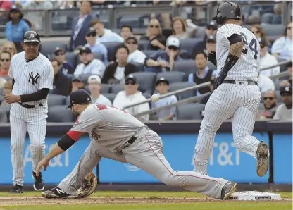  ?? AP PHOTOS ?? ToUGH aFTeRnoon: Mitch Moreland (above) can’t handle an errant throw by Rafael devers on an infield single by Gary sanchez in the first inning, and Matt Holliday (right) is congratula­ted by Chase Headley (12) after hitting a three-run homer in the...