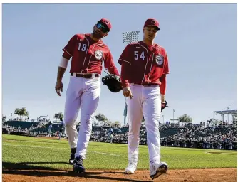  ?? ASSOCIATED PRESS ?? Reds pitcher Sonny Gray (54), here walking off the field with first baseman Joey Votto during Wednesday’s game against the Mariners, says he’s no longer in pain after offseason surgery to remove bone chips from his right (throwing) elbow. Gray went 11-8 with a 2.87 ERA last season.