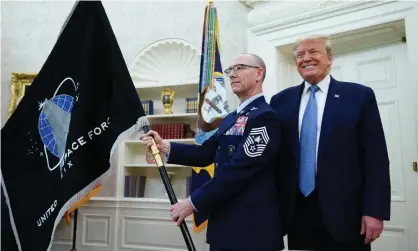  ??  ?? Donald Trump next to the the US space force flag on 15 May 2020, in the Oval Office. Photograph: Mandel Ngan/AFP via Getty Images