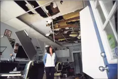  ?? Tyler Sizemore / Hearst Connecticu­t Media ?? Business owner Suzann Benevelli surveys the fire damage to Belltown Barbers in Stamford.