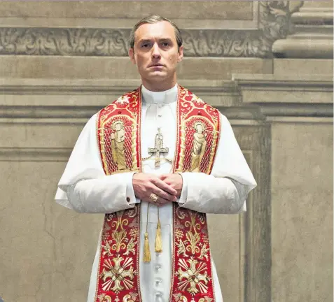  ??  ?? Mass appeal: Law played a cardinal who ascends to the papacy in The Young Pope, above; and with his wife Phillipa last year