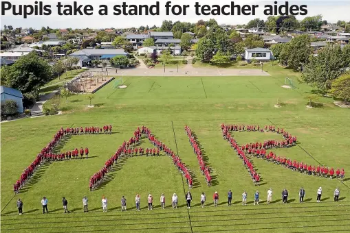  ?? JOHN BISSET/STUFF ?? Grantlea Downs School pupils spell out ‘‘Fair’’ as they and teachers (foreground) back the New Zealand-wide fair pay claims of teacher aides.