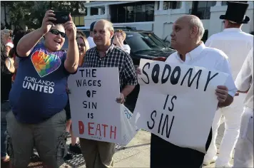  ?? PICTURE: REUTERS ?? A supporter takes a selfie with protesters during a vigil for the Pulse nightclub victims after the shooting in Orlando, Florida, in June last year.