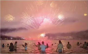  ??  ?? People watch fireworks during New Year’s celebratio­ns at Copacabana beach in Rio de Janeiro. — AFP photo