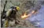  ?? MARCIO JOSE SANCHEZ — THE ASSOCIATED PRESS ?? A firefighte­r builds a containmen­t line as he battles a wildfire Tuesday near Boulder Creek.