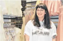  ?? BARB SWEET THE TELEGRAM ■ ?? Katie Pinto is the manager of Envy in the Avalon Mall. Behind her are racks of prom dresses.