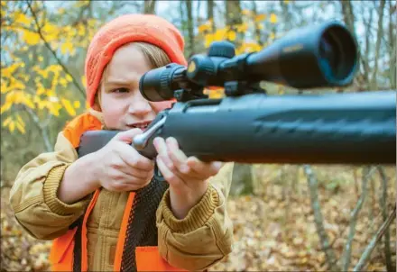  ??  ?? WILLIAM HARVEY/THREE RIVERS EDITION
T.A. Lewis looks down the scope of his rifle as he did when he shot one of the three deer that he killed to get the Triple Trophy Award.