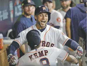  ?? DAVID J. PHILLIP/ASSOCIATED PRESS ?? The Astros’ George Springer celebrates his solo home run with teammate Tony Kemp during Game 1 of an American League Division Series game against the Indians on Oct. 5 in Houston.